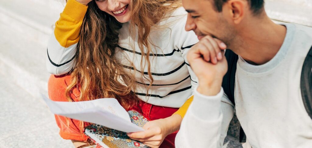 A couple sitting together looking at a paper with strategies that have come up with during their ADHD-Focused Couples Therapy in NYC.