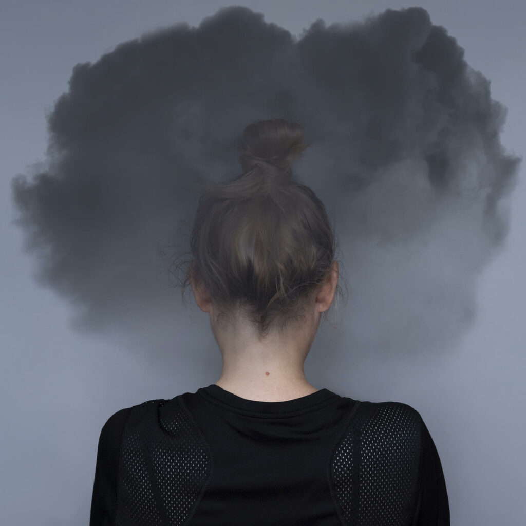Girl with a black cloud surrounding her head representing the symptoms of ADHD when undiagnosed. ADHD Testing in NYC can help determine what course of action is best moving forward.