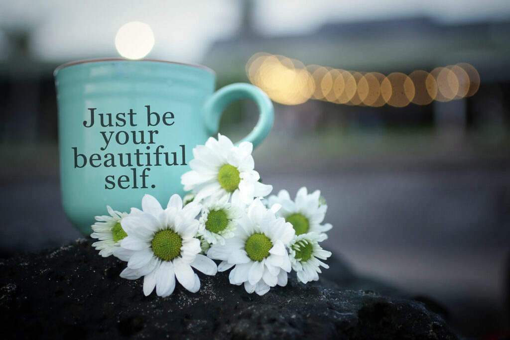 bluse cup - ADHD-focused therapy in NYC - ADHD-focused therapy for anxiety - ADHD-focused therapy for depression - 10018 - 10010 - 10003 - 10011 - 10012 White flowers with a blue coffee cup sitting next to it that says "Just be your beautiful self" representing the need to accept and embrace your ADHD diagnosis with the help of ADHD-Focused Therapy in NYC.