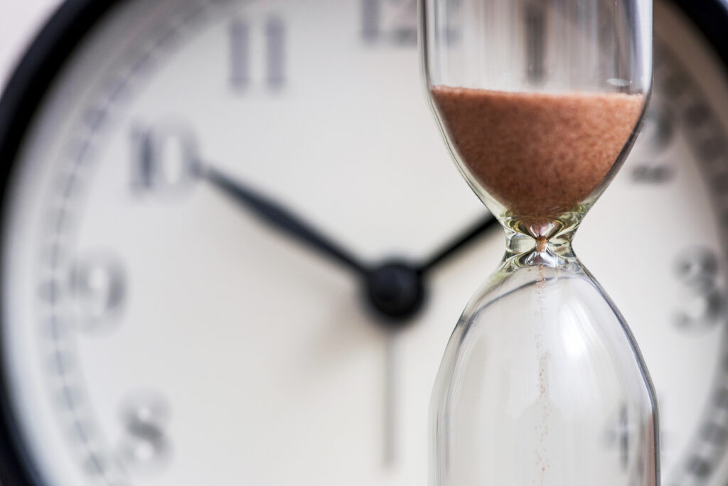 hourglass and clock | adhd therapist in nyc | adhd and rumination in nyc | adhd therapist in new york, ny | 10003 | 10011 | 10012 A close up of an hourglass in front of a clock. Learn how an ADHD therapist in NYC can support you in overcoming ruminating thoughts. An ADHD therapist in New York, NY can offer support today.